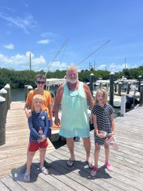 A cheerful group of children and an adult pose together at the dock, ready for a day of boating adventures. Perfect for family outings and fun on the water.