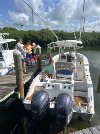 A family prepares to board a boat at the dock, showcasing a lively atmosphere of anticipation for a day on the water.