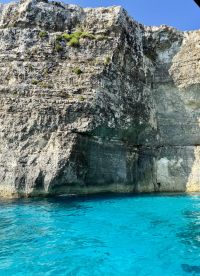 A stunning view of a rocky coastline with vibrant turquoise waters, perfect for showcasing the natural beauty of the area.