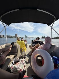 A lively group enjoys a relaxing day on a pontoon boat, taking in the scenic views while lounging on the water. Perfect for a fun day out with friends or family.