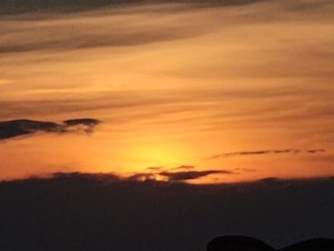 A stunning sunset casts vibrant hues across the sky, creating a picturesque backdrop for evening boat adventures.