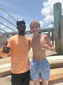 A joyful moment captured with two individuals posing together, showcasing a fun day on the water. Perfect for highlighting memorable experiences during boating adventures.