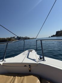 A clear view from the front of a speedboat, showcasing the calm waters and coastal scenery ahead — perfect for a day of exploration on the water.