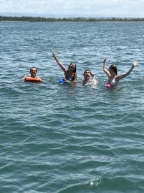 A lively group enjoys a fun day in the water, celebrating with laughter and splashes — perfect for summer adventures and memorable outings.
