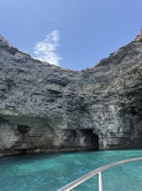 A stunning view of a natural cave with turquoise waters, showcasing the breathtaking scenery often explored during boat tours.