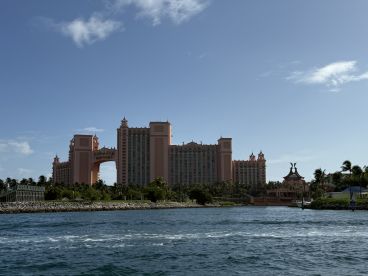 A stunning view of the iconic Atlantis Resort in the Bahamas, showcasing its unique architecture against a clear blue sky — a perfect backdrop for any boating adventure.