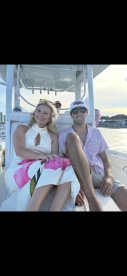A couple enjoys a relaxing moment on a boat, perfect for romantic outings or sunset cruises.