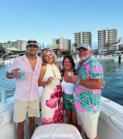 A cheerful group enjoys cocktails on a boat, celebrating together against a vibrant waterfront backdrop — perfect for memorable outings and gatherings.