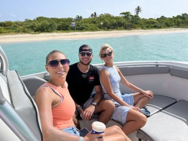 A cheerful group enjoys a sunny day on a boat, perfect for creating unforgettable memories on the water.
