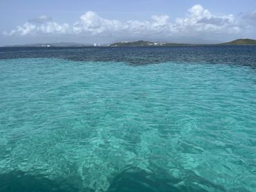 A scenic view of clear turquoise waters, but the image lacks clarity and focus.