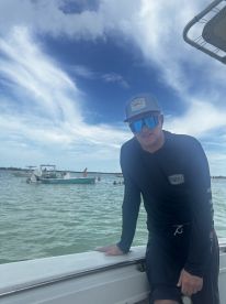A man enjoys a day on the water, showcasing the vibrant atmosphere of boating with friends and family. Perfect for capturing memorable moments on the water.