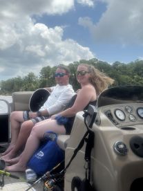A couple enjoys a relaxing moment on a boat, capturing the essence of a perfect day on the water.