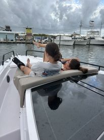 Two friends relax on the deck of a boat, enjoying a leisurely day on the water — perfect for unwinding and soaking up the sun.