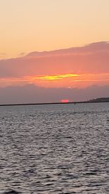 A stunning sunset over the water, creating a picturesque scene perfect for evening boat cruises and relaxation.