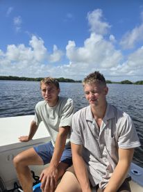 Two friends enjoy a sunny day on the water, capturing the essence of a fun boating experience.