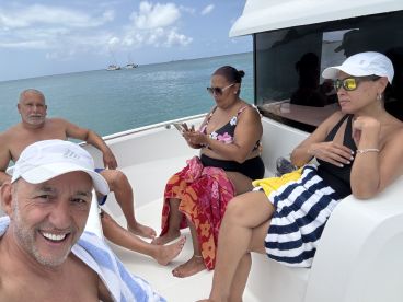 A group of friends enjoys a relaxing day on the boat, soaking up the sun and the ocean views — perfect for a fun day out on the water.