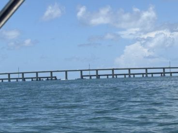 A view of a bridge over water, captured from a boat, but the image lacks clarity and detail.