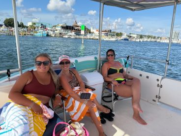 Three friends enjoy a sunny day on a boat, relaxing and soaking up the atmosphere — perfect for a fun day on the water.
