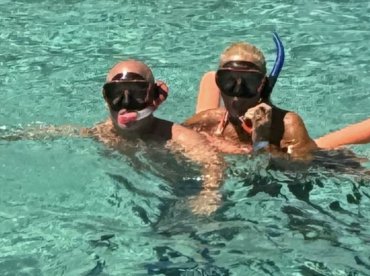 A couple enjoys snorkeling in clear waters, showcasing a fun and adventurous underwater experience.
