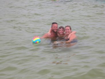 A joyful family enjoys a fun day swimming together in the water, creating lasting memories during their aquatic adventure.