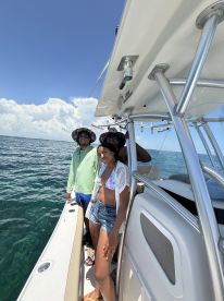 A cheerful group of friends enjoys a sunny day on the boat, perfect for creating unforgettable memories on the water.