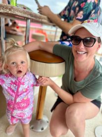 A joyful moment captured of a mother and her young daughter enjoying their time on a boat, showcasing the fun and bonding experiences that family outings can bring.