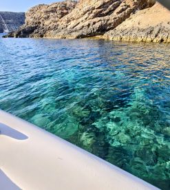 A view of clear turquoise waters near rocky terrain, but the image lacks clarity and focus.