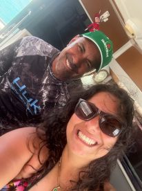 A joyful selfie featuring two individuals aboard a boat, capturing a moment of fun and camaraderie on the water.