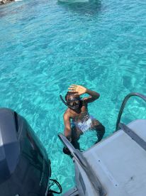 A child enjoys snorkeling in crystal-clear waters, showcasing the fun and adventure of underwater exploration.