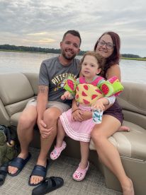 A joyful family enjoys a relaxing moment on a boat, capturing the essence of fun and togetherness on the water.