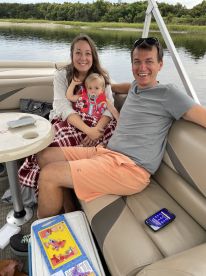 A happy family enjoys a relaxing moment on a boat, showcasing smiles and togetherness — perfect for family outings on the water.