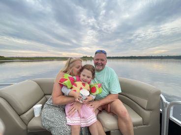 A joyful family enjoys a serene moment on a boat, capturing the essence of quality time together on the water.