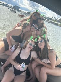 A fun group of friends celebrates together on a boat, enjoying drinks and laughter — perfect for bachelorette parties or summer outings.