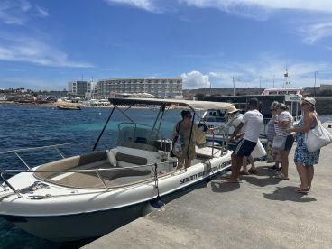 A lively group boards a boat at the harbor, ready for an exciting day on the water — perfect for group adventures and excursions.