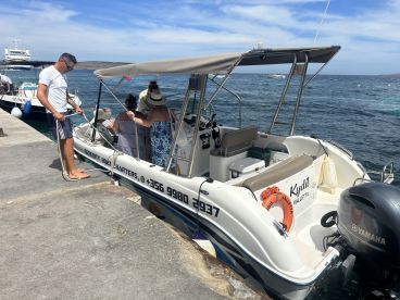 Guests board a charter boat at the dock, preparing for an exciting day on the water — perfect for exploring coastal destinations.