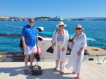 A cheerful group poses by their boat, ready for a day of adventure on the water. Perfect for family outings or friends' getaways.