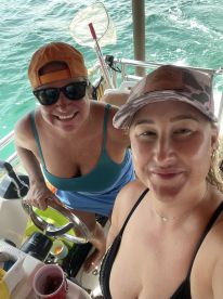 Two friends enjoy a fun moment on a boat, showcasing camaraderie and relaxation on the water, perfect for a day of adventure.