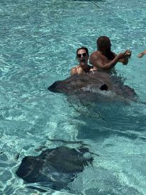A thrilling encounter as guests interact with stingrays in crystal-clear waters, showcasing an unforgettable wildlife experience in the Bahamas.