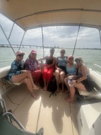 A group of friends enjoys a fun day on the boat, showcasing camaraderie and relaxation on the water — perfect for a memorable outing.