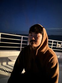 A contemplative moment captured on a boat at night, showcasing the serene atmosphere of evening cruises.