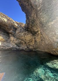 A view of rocky cliffs and clear water, but the image lacks clarity and focus.