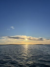 A stunning sunset over tranquil waters, showcasing the beauty of nature — perfect for romantic evenings or peaceful boat rides.