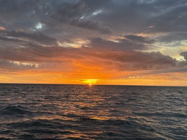 A breathtaking sunset over the ocean, showcasing vibrant colors and serene waters — perfect for romantic evenings or peaceful boat rides.