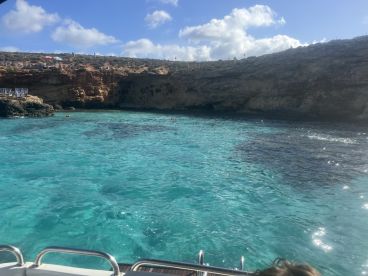 A stunning view of turquoise waters and rocky coastline, perfect for exploring and enjoying the beauty of nature during a boat trip.