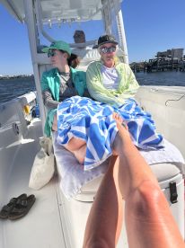 A group of friends relaxes on a boat, enjoying the sun and water views — perfect for a day of leisure on the water.