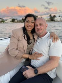 A couple enjoys a romantic moment on a boat, surrounded by a picturesque sunset — perfect for intimate celebrations or special occasions on the water.