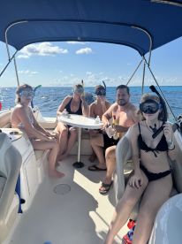 A group of friends prepares for a snorkeling adventure aboard a boat, showcasing the excitement of on-water activities and camaraderie.