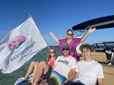 A joyful family enjoys a day on the water, celebrating together aboard a boat in the beautiful Keys, creating unforgettable memories.