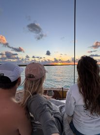 A couple enjoys a stunning sunset view from their boat, creating a perfect romantic atmosphere for memorable moments on the water.