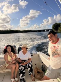 A group of friends enjoys a sunny day on the water, capturing the essence of fun and relaxation aboard their boat.